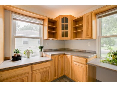 Large, bright windows make this corner kitchen bri