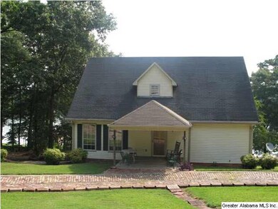 BACK VIEW WITH NICE SITTING COVERED PORCH. CIRCLE 