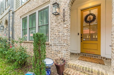 View of exterior entry with brick siding