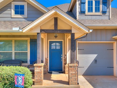 View of exterior entry with an attached garage, bo