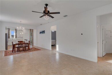 Dining space featuring a chandelier, a ceiling fan, and light tile patterned flooring