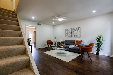 Living room with stairway, recessed lighting, a c