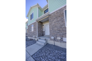Entrance to property featuring stone siding
