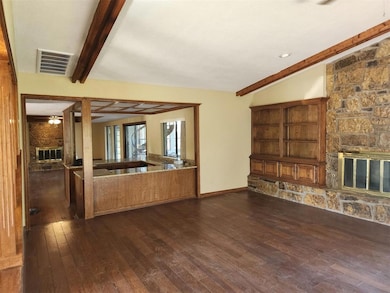 Unfurnished living room featuring visible vents, b