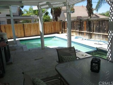 In-ground pool and spa with covered patio.
