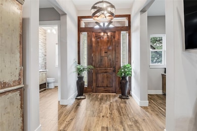 Foyer entrance featuring light wood finished floo