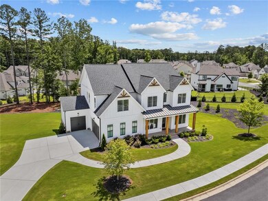 Modern farmhouse style home featuring board and batten siding, covered porch, concrete driveway, a shingled roof, and a residential view