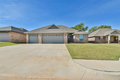 Single story home featuring a shingled roof, a front lawn, brick siding, driveway, and an attached garage