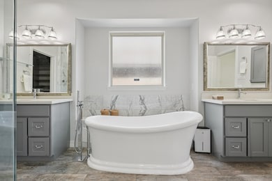 Unwind after a long day in the elegant stand alone soaking tub.