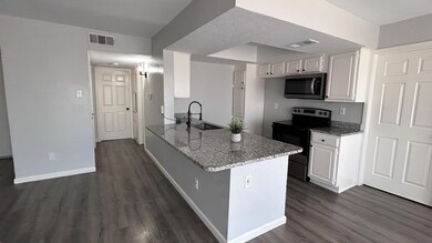 Kitchen featuring white cabinets, electric range, 