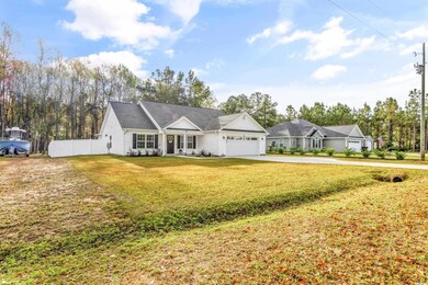 Ranch-style home featuring a front lawn and a gara
