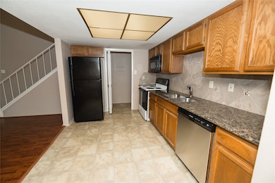 Granite counters and a coordinating backsplash giv