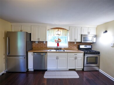 White kitchen, gas oven stainless steel appliances