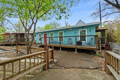Back of house with a sunroom and a wooden deck