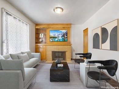 Living area featuring a fireplace, built in features, and a textured ceiling
