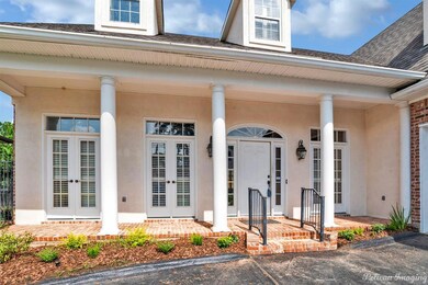 Covered front porch with lights on either side of 