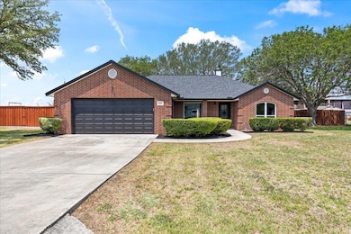 View of front of property with a garage, brick si