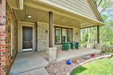 Property entrance featuring brick siding and cover