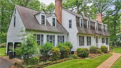 View of front of property with a chimney and a fro