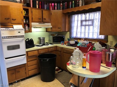 Kitchen featuring light tile flooring and white appliances
