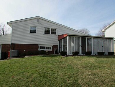 Exterior Back. Enclosed porch with views of the ba