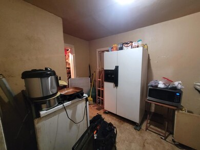 Kitchen with white refrigerator with ice dispenser