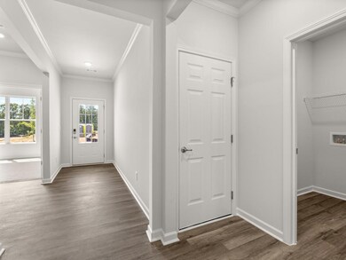 Aria front entry hallway with access to the laundry room