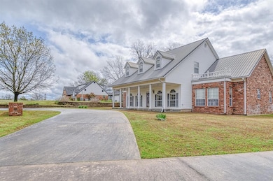 New england style home featuring concrete driveway