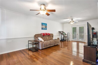 View from foyer with hardwoods to French doors to