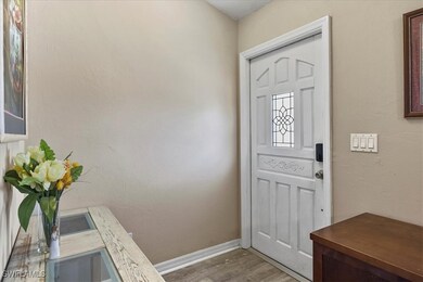 Entryway featuring baseboards and wood look finish