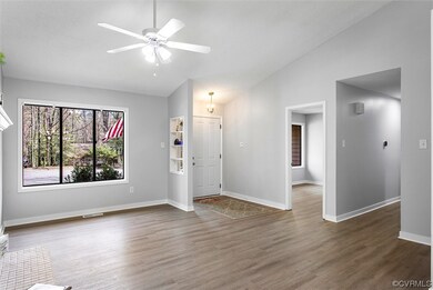 LVP floored livingroom with natural light, a ceili