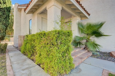 Doorway to property featuring stucco siding, a til