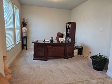 Office area featuring light colored carpet and ple