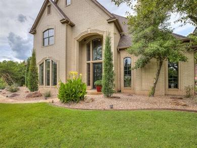View of front of property featuring brick siding, a front yard, and roof with shingles
