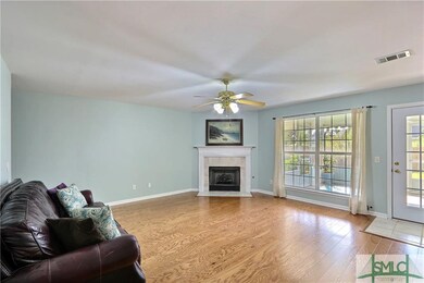 Great room with gas fireplace, new wood floors and