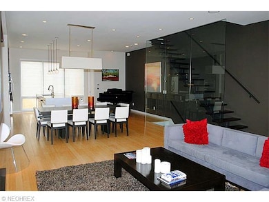 Kitchen and dining area with view of stairs and gl