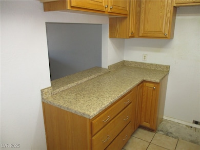Kitchen featuring light tile patterned flooring an