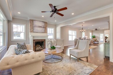 Natural light abounds in this home.  Gorgeous living room with all exposed brick being original to the home.  