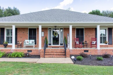 Fabulous sitting porch with a beautiful entry way.