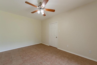 Unfurnished room featuring a ceiling fan and base