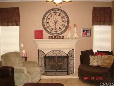 Family room with stone like fireplace hearth and m