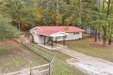 Bungalow with driveway, a carport, and a metal roof