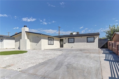 Ranch-style house featuring stucco siding and a chimney