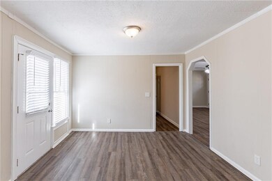 Empty room with crown molding, dark hardwood / woo