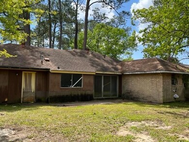 Rear view of home.  Sliding glass door with large