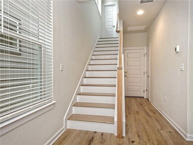Stairway featuring visible vents, baseboards, and