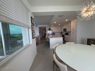 Dining area featuring , tile patterned flooring, and a chandelier
