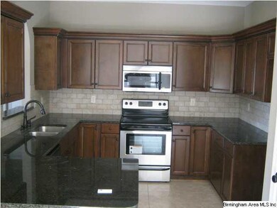 Kitchen with stainless appliances, granite counter