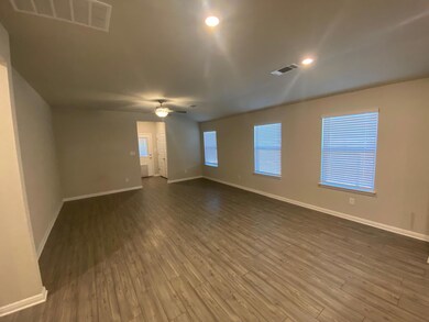Spare room featuring dark wood-style floors, rece