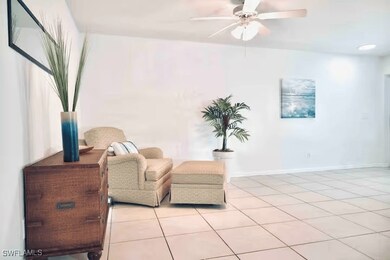 Sitting room with a ceiling fan, light tile patter